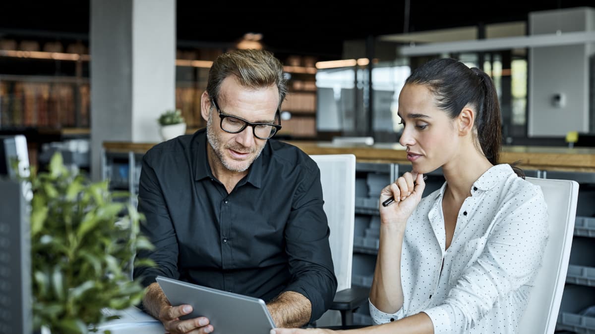 colleagues looking togehter on a tablet