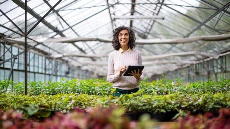 woman gardening with tablet in her hand