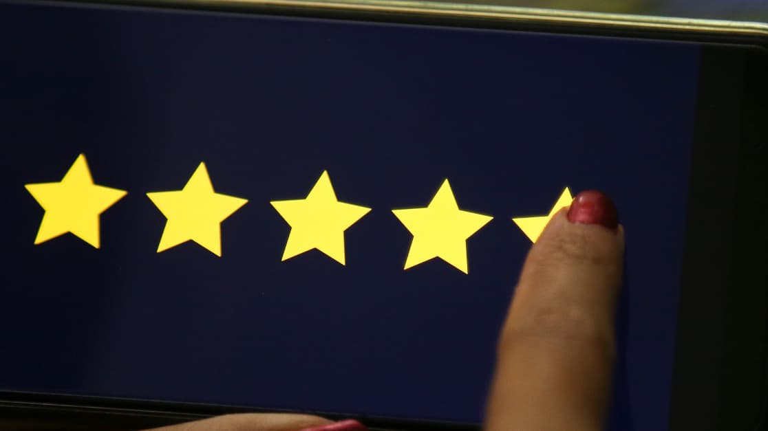 Manager giving five star rating on smartphone