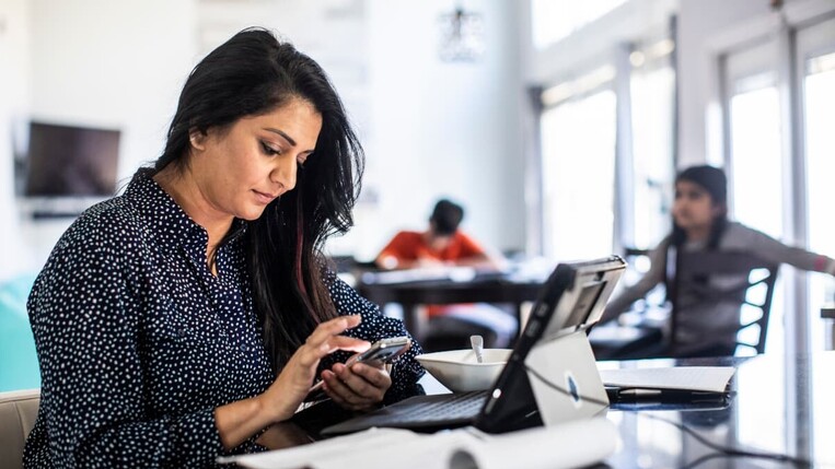 woman with laptop and phone