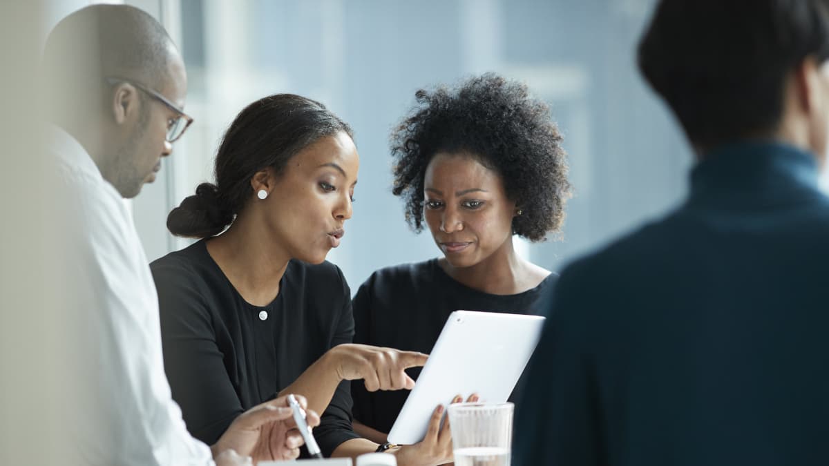 colleagues looking together on a tablet