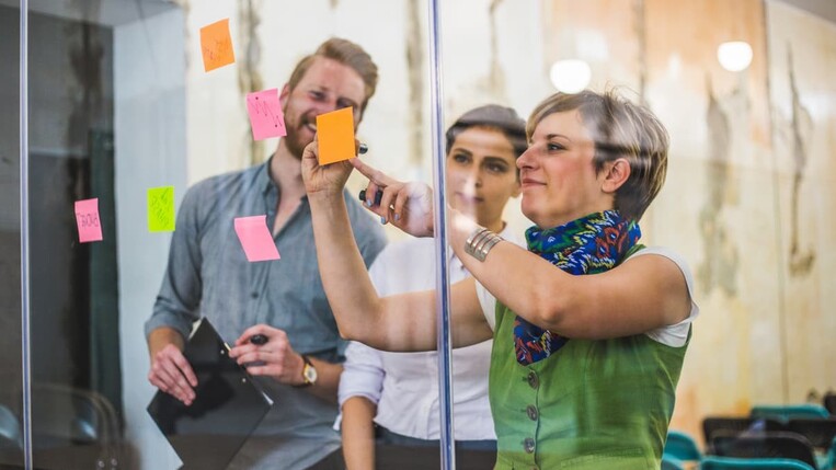 workers writing on sticky notes