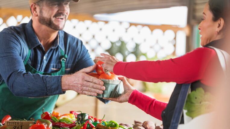 buying tomatos at the market