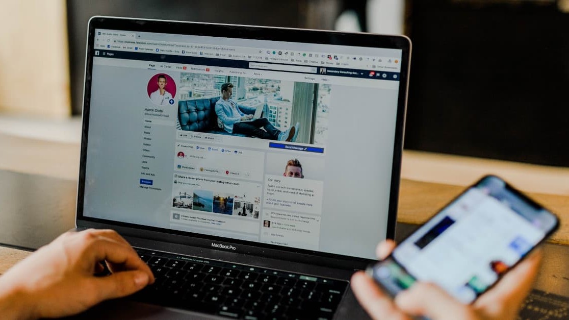 Man checking laptop for B2B companies with great social media visibility