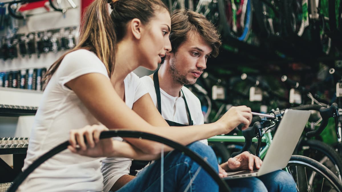 guy and girl looking on their laptop