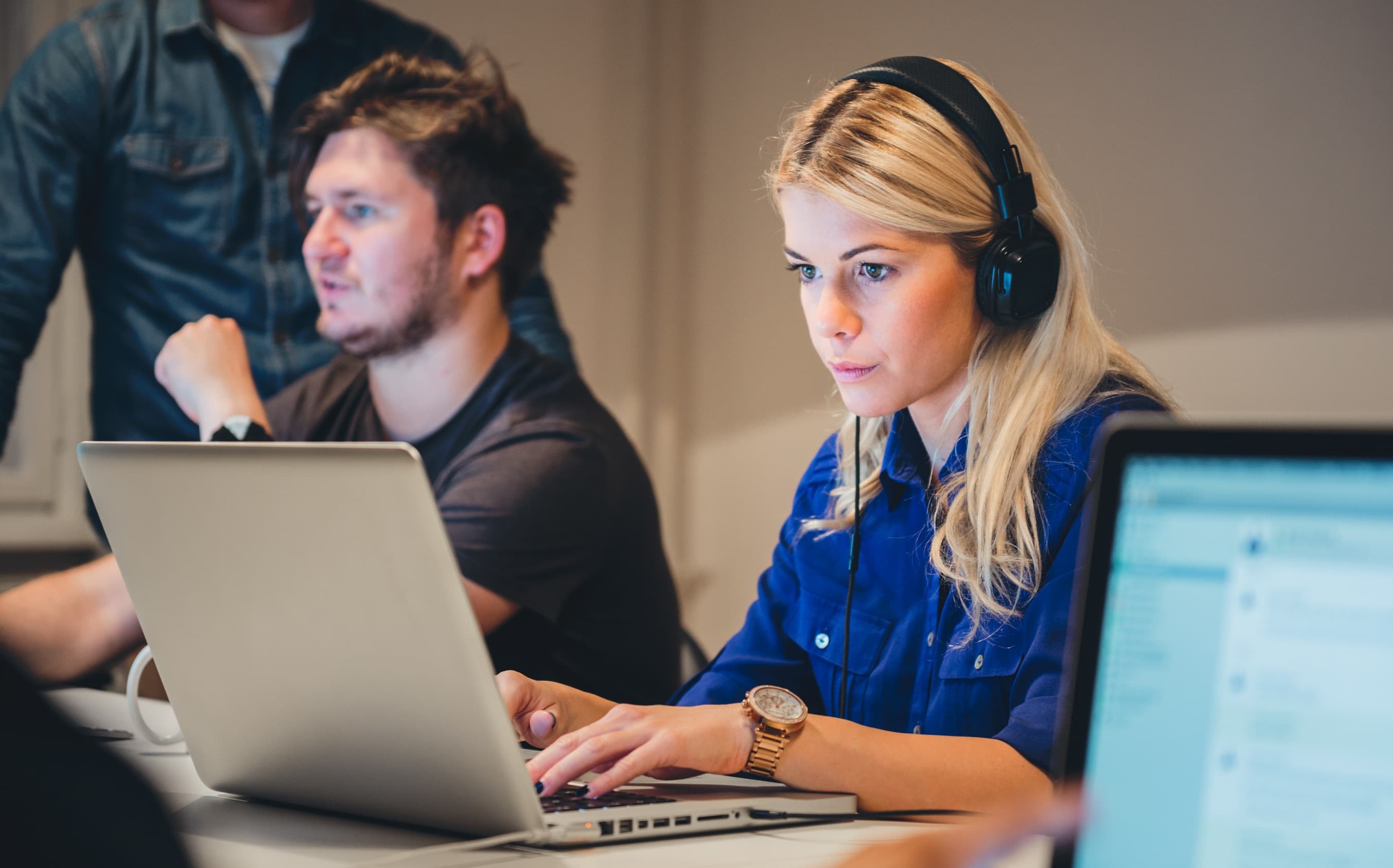 Woman designing a call to action on a laptop