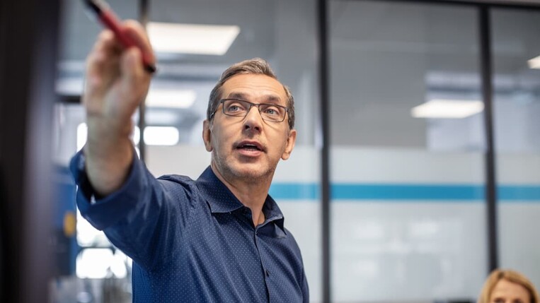 man pointing at something with a pen